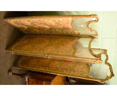 A gilt and glass four folding panel screen