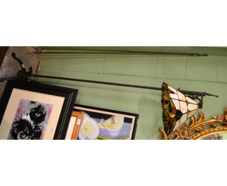 A cast iron standard lamp with stained glass shade