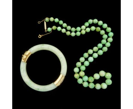 Early 20th century single strand graduating jade bead necklace, with 10ct gold clasp and a later 14ct gold jade hinged bangle