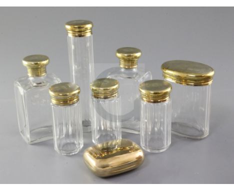 A George V Asprey & Co seven piece engine turned silver gilt-topped glass toilet set, London, 1920 and an Asprey & Co silver 
