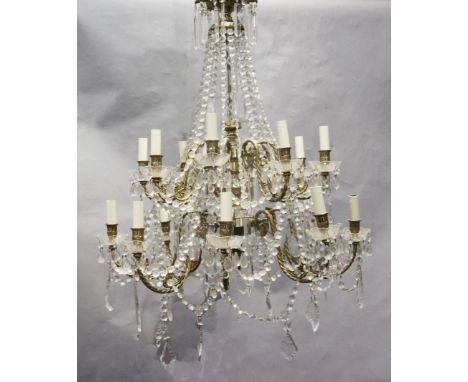 An 18th century style gilt brass and glass sixteen light chandelier, hung with lustre and tear shaped drops, drop 3ft 6in. di