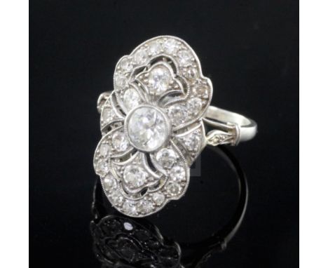 An attractive early 20th century French platinum and diamond cluster upfinger dress ring, of shaped oval form and set with mi