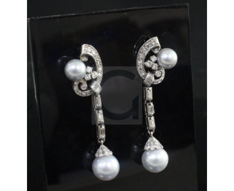 A pair of white gold diamond and Tahitian cultured pearl drop earrings, of scrolling design and set with baguette and round c