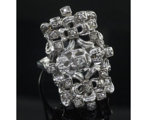 An 18ct white gold and diamond set modernist dress ring, of free form rectangular design, size V.