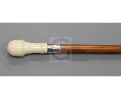 A late Victorian malacca walking stick, with silver banded ivory knop, opening to house a set of bone dominoes, 35in.