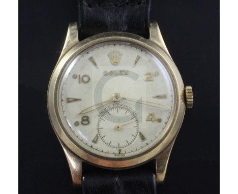 A gentleman's early 1950's 9ct gold mid size Rolex manual wind wrist watch, with Arabic and arrow head numerals and subsidiar
