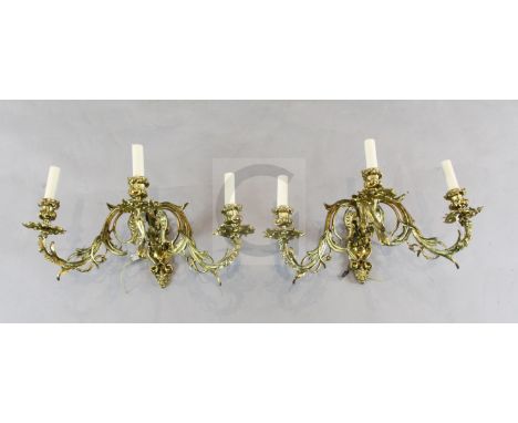 A pair of ormolu three light wall appliques, of scrolled foliate form, each wall plate cast with a foliate grotesque mask, he