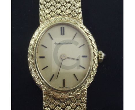 A lady's 18ct gold Jaeger Le-Coultre manual wind dress wrist watch, with oval dial and baton numerals, on integral 18ct gold 