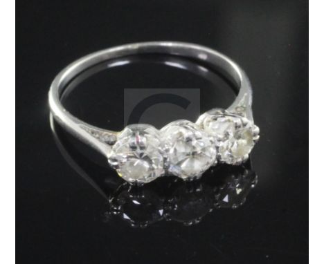 A mid 20th century white gold and three stone diamond ring, size N.