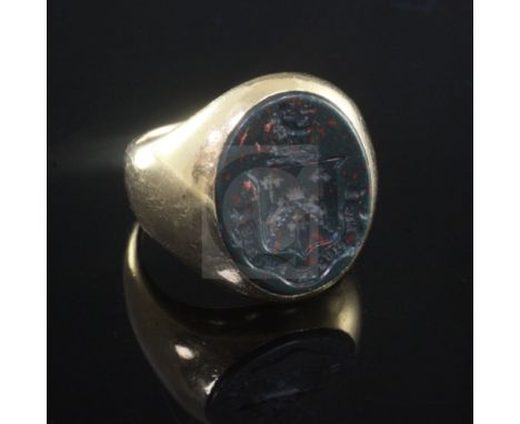 A George V 18ct gold and bloodstone signet ring, carved with the Barlow family crest, Chester, 1923, size L.