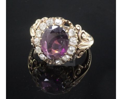 A 19th century gold rhodolite? garnet and rose cut diamond oval dress ring, with carved shoulders, (two stones missing), size