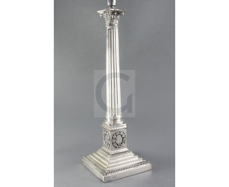 A 20th century silver plated corinthian column table lamp, the pedestal decorated with laurel wreaths, on stepped square base