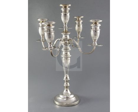 A George V silver four branch, five light candelabrum by Sigmund Zyto, with four scroll arms and fluted tapered stem, London,