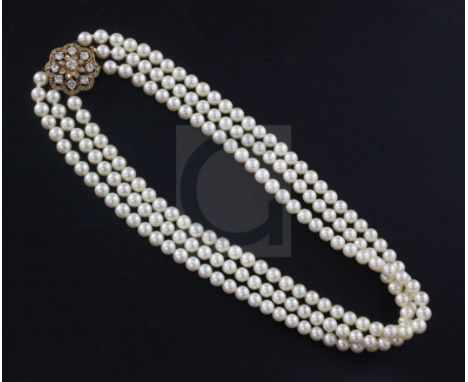 A 1980's triple strand cultured pearl choker necklace with 18ct gold and diamond cluster set clasp, 36cm.From the estate of t