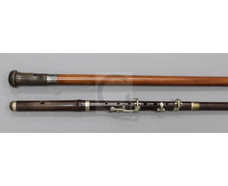 A rosewood walking stick with 'flute' handle, 35.5in., and a horn knopped malacca cane, 34.5in.