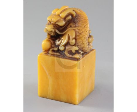 A Chinese shoushan stone seal, the top carved with a dragon with pearl, four character matrix, height 14.3cm