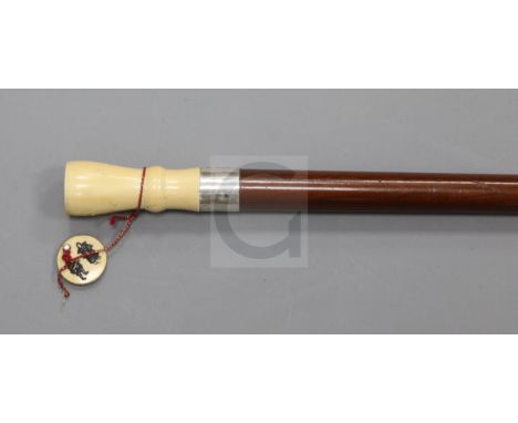 A late Victorian hardwood walking stick, with silver banded Japanese ivory panel opening to reveal a set of miniature playing