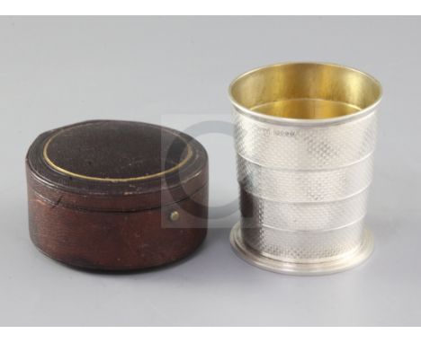 A cased Victorian engine turned silver telescopic travelling beaker, Henry William Dee, London, 1869, open 75mm, 5.8 oz.
