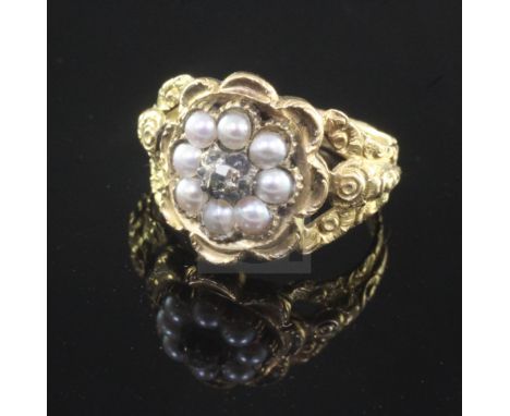 A Georgian gold, diamond and split pearl mourning ring, with carved and pierced shoulders, the interior shank with hair benea