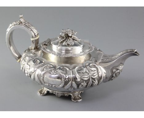 A good William IV Irish silver teapot by Richard Sawyer, of squat inverted pear form and embossed with flowers and scrolls, o