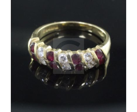 An 18ct ruby and diamond half hoop dress ring, size O.From the estate of the late Sheila Farebrother.