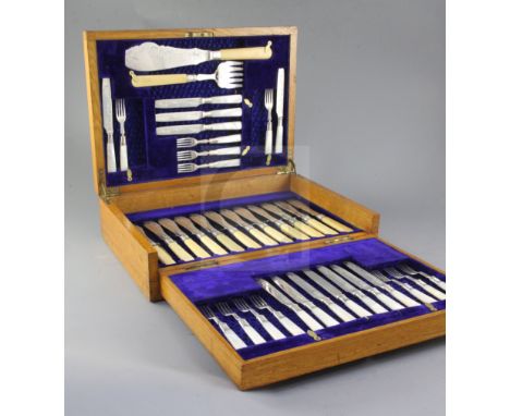 A George V silver service in oak fitted case, comprising twelve pairs of mother of pearl handled silver dessert eaters and tw