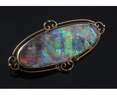 An Edwardian 9ct gold and black opal brooch, of oval form, the opal length approximately 41mm, 51mm.