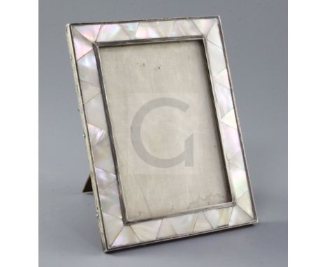 A 1920's silver and mother of pearl mounted photograph frame by Padgett & Braham, of rectangular form, with engine turned inn