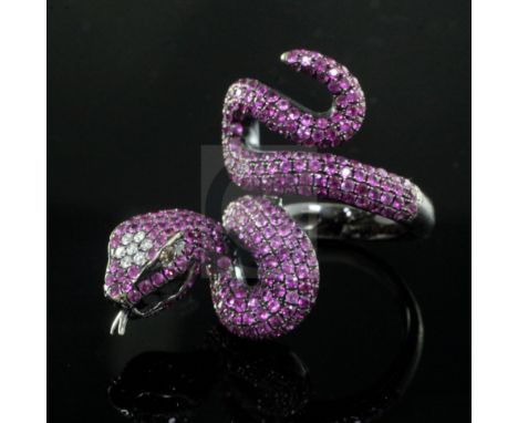 A modern blackened? gold, diamond and ruby encrusted serpent ring, size N.