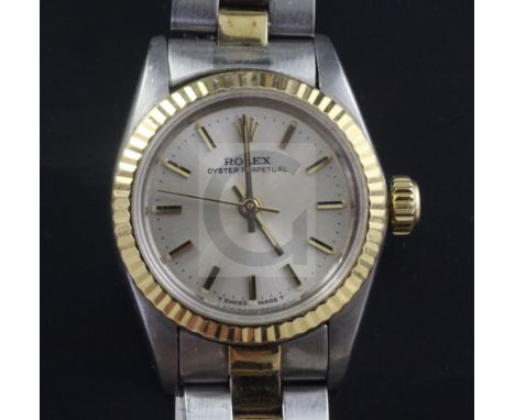 A lady's 1980's gold and steel Rolex Oyster Perpetual wrist watch, with baton numerals, model no. 67193, serial no. 8465976.