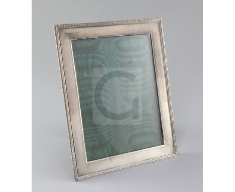 A George V engine turned silver mounted photograph frame by Asprey & Co, of rectangular form, with decorated border, London, 