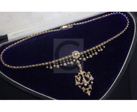 A late Victorian 15ct gold and seed pearl set pendant necklace, the detachable pendant brooch of foliate scroll form, chain 3