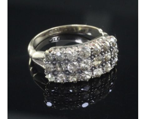 An 18ct gold triple row diamond ring, set with twenty one old round cut stones, size O.