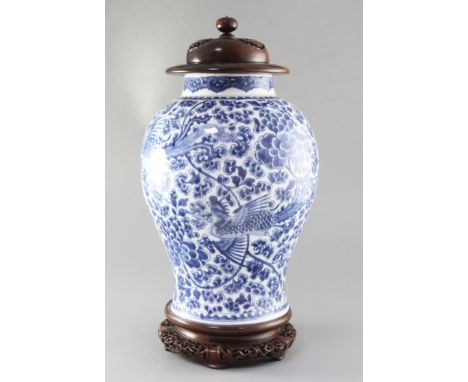A Chinese blue and white 'phoenix and peony' jar, Kangxi period, of baluster form, profusely painted with four phoenixes amid