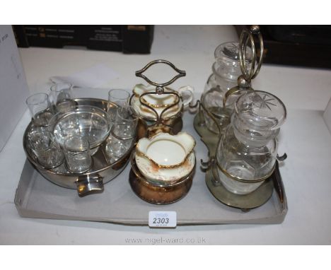 A pair of pickle jars and pickle fork on a silver plated stand, shot glasses in a plated dish and a Royal Devon sugar bowl an