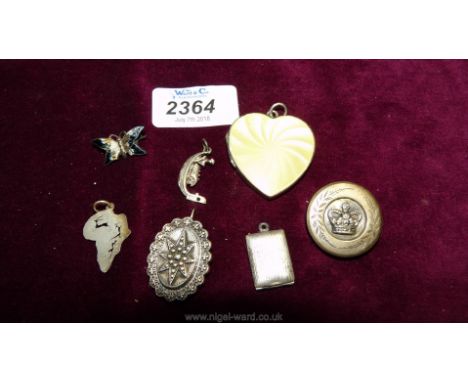 A white metal and enamel heart-shaped pendant locket, silver charms, brooches, etc