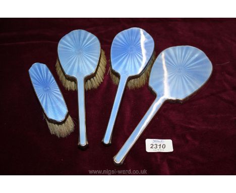 A four piece Silver and blue enamel Dressing Table set comprising three brushes and a hand mirror