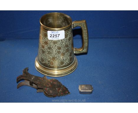 A profusely decorated brass Tankard with a decorative brass and enamel paper clip, etc