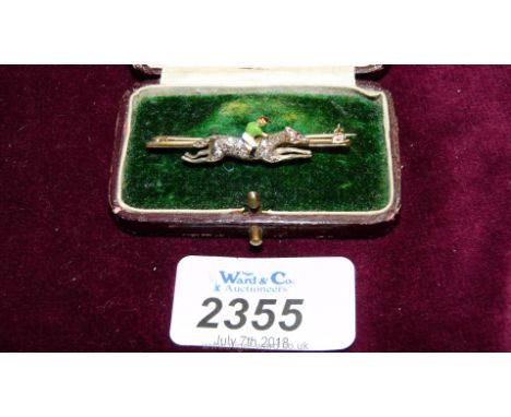 A 15ct gold Jockey and Horse brooch with diamonds and enamel.