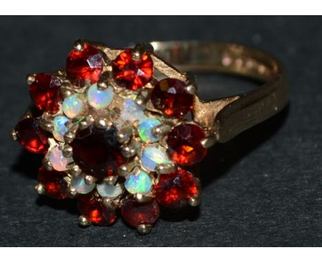 A 9ct gold cluster ring, set with garnets and opal, 3.3g