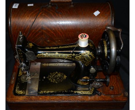 A Singer manual sewing machine, cased