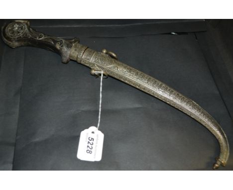 A Moroccan jambiya, 23.5cm curved blade, hardwood grip inlaid with silvered wire, chased scabbard, 41cm long overall