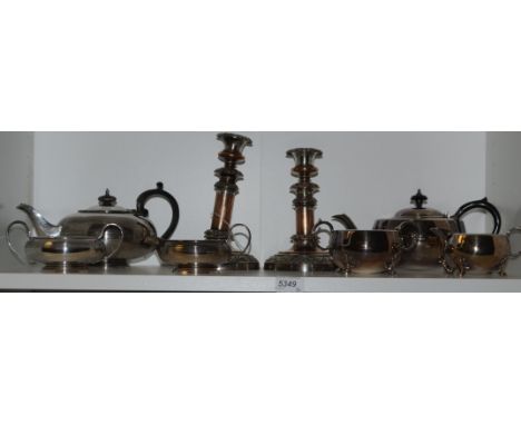 A pair of Sheffield plate, silver on copper candlesticks, early 18th century; an EPNS three piece tea service; another 