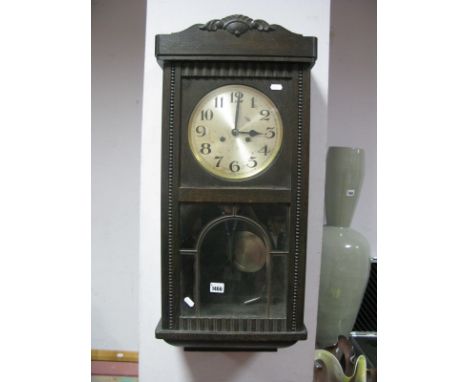 An Early XX Century Oak Cased Wall Clock, silvered dial, Arabic numerals.