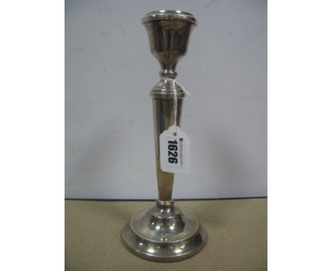 A Hallmarked Silver Candlestick, PH Vogel &amp; Co, Birmingham 1974, of plain tapering form on circular spreading base, (base
