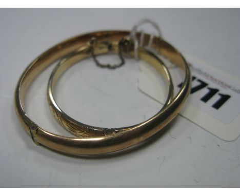 A 9ct Gold Plain Bangle, to snap clasp, together with another similar child's bangle, foliate engraved detail, to snap clasp,