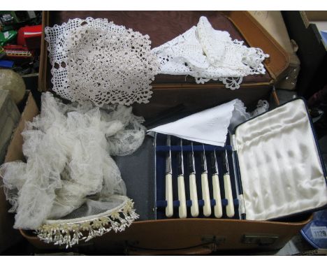 A Bridal Coronet and Veil, doilies, fish knives and fork, (cased), fruit knives, (cased) in a vintage tan suitcase.