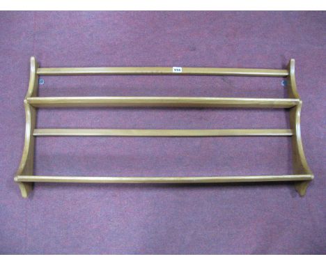 An Ercol Light Elm Two Heights Open Wall Rack, Ercol sticker to base No. 268, length 97 cm. 