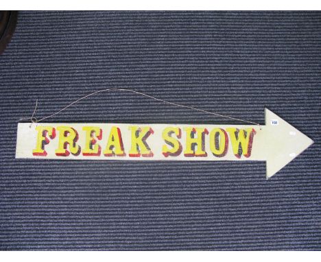 A Cut Wooden Arrow, painted with the words "Freak Show", c.120cm long.