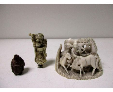 A 19th century ivory group of Mu Wang together with a netsuke and an ojime, the philosopher stands amongst rocks studying eig